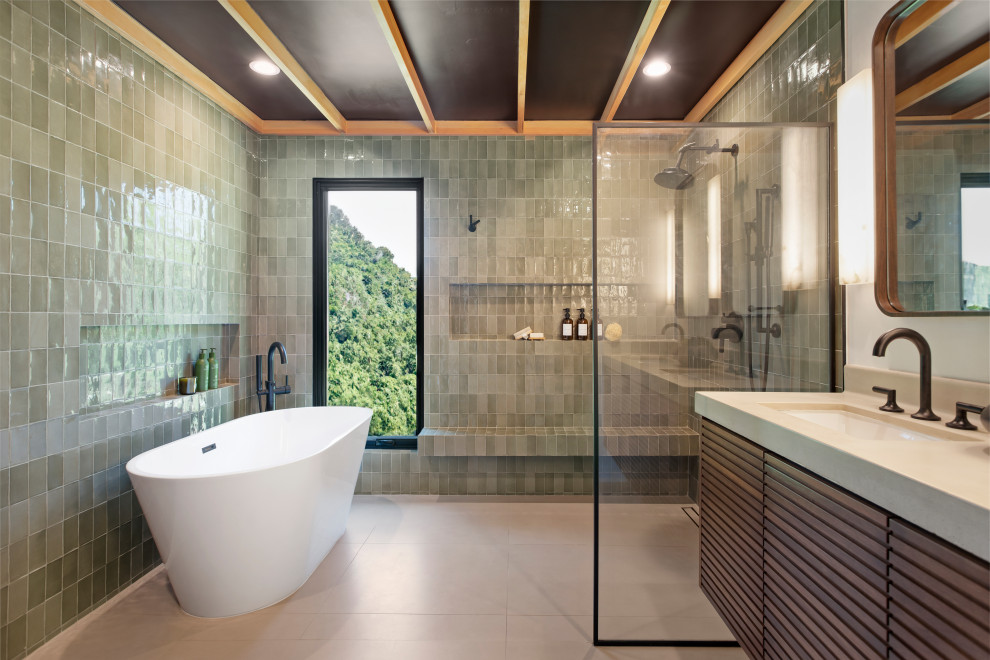 Photo of a large contemporary bathroom in Los Angeles with medium wood cabinets, a freestanding tub, a bidet, green tile, porcelain tile, white walls, porcelain floors, an integrated sink, concrete benchtops, grey floor, grey benchtops, a niche, a double vanity, a floating vanity and wood.