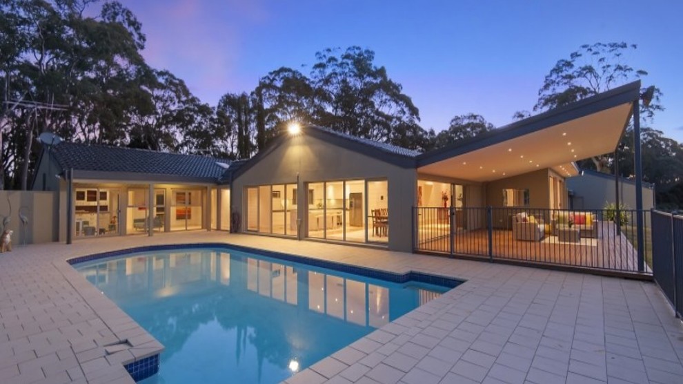 Inspiration for a mid-sized contemporary side yard rectangular pool in Sydney with brick pavers.