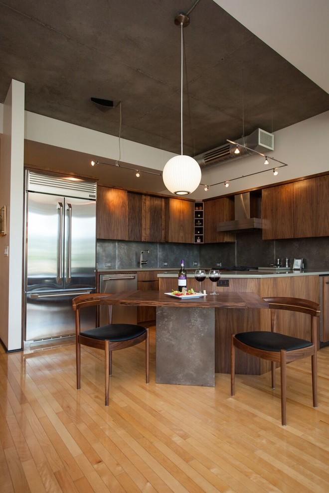 Inspiration for a mid-sized contemporary l-shaped open plan kitchen in Portland with flat-panel cabinets, medium wood cabinets, stainless steel appliances, light hardwood floors and a peninsula.