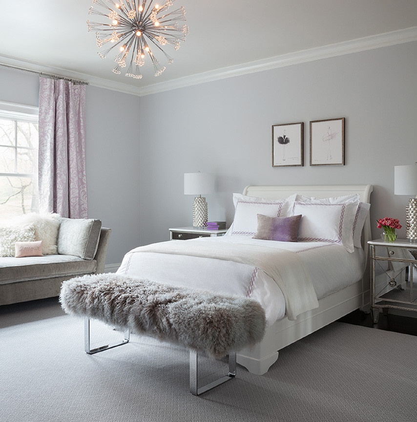 This is an example of a large transitional bedroom in New York with purple walls and dark hardwood floors.