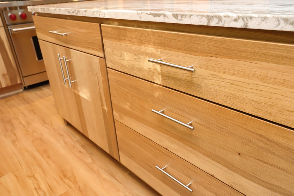 Mid-sized transitional u-shaped light wood floor and brown floor eat-in kitchen photo in Grand Rapids with an undermount sink, flat-panel cabinets, light wood cabinets, quartz countertops, brown backsplash, ceramic backsplash, stainless steel appliances and an island