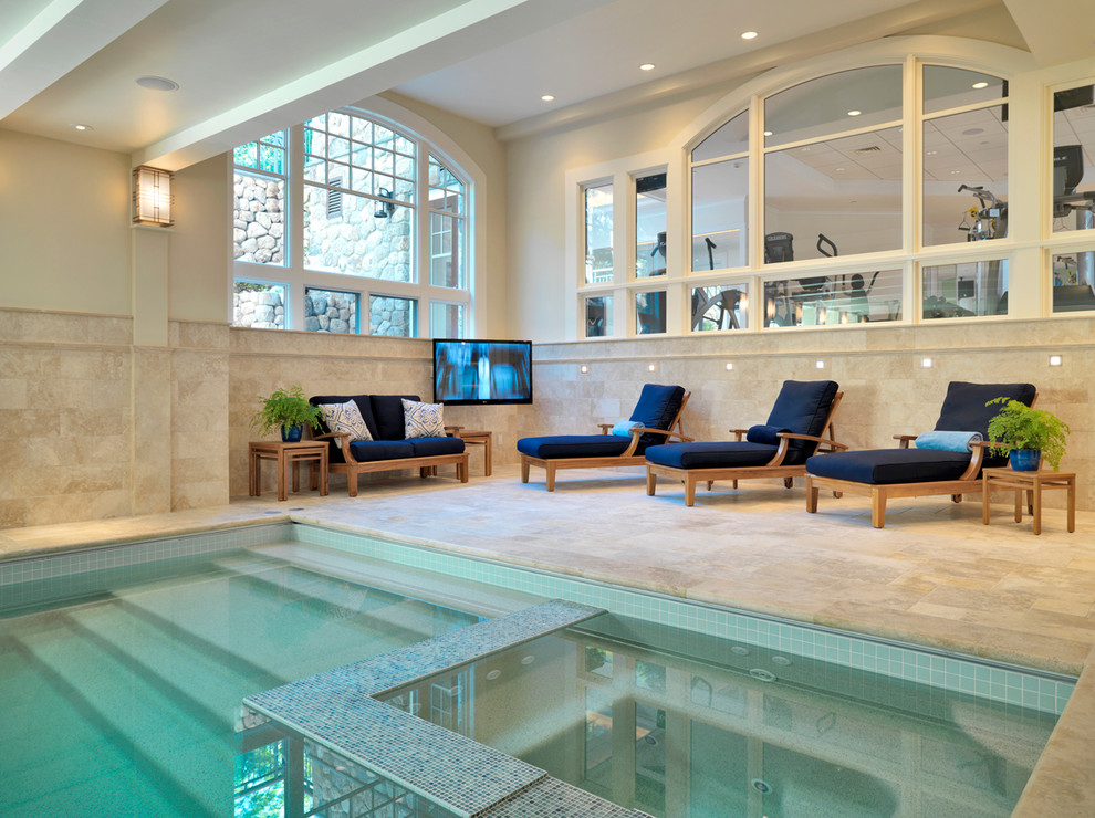 Inspiration for a traditional indoor pool in Boston with natural stone pavers.
