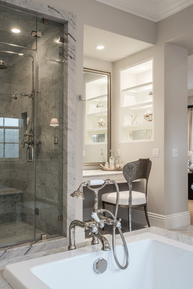 Large transitional master bathroom in Orange County with shaker cabinets, white cabinets, marble benchtops, a drop-in tub, an alcove shower, white tile, stone tile, beige walls, marble floors and an undermount sink.