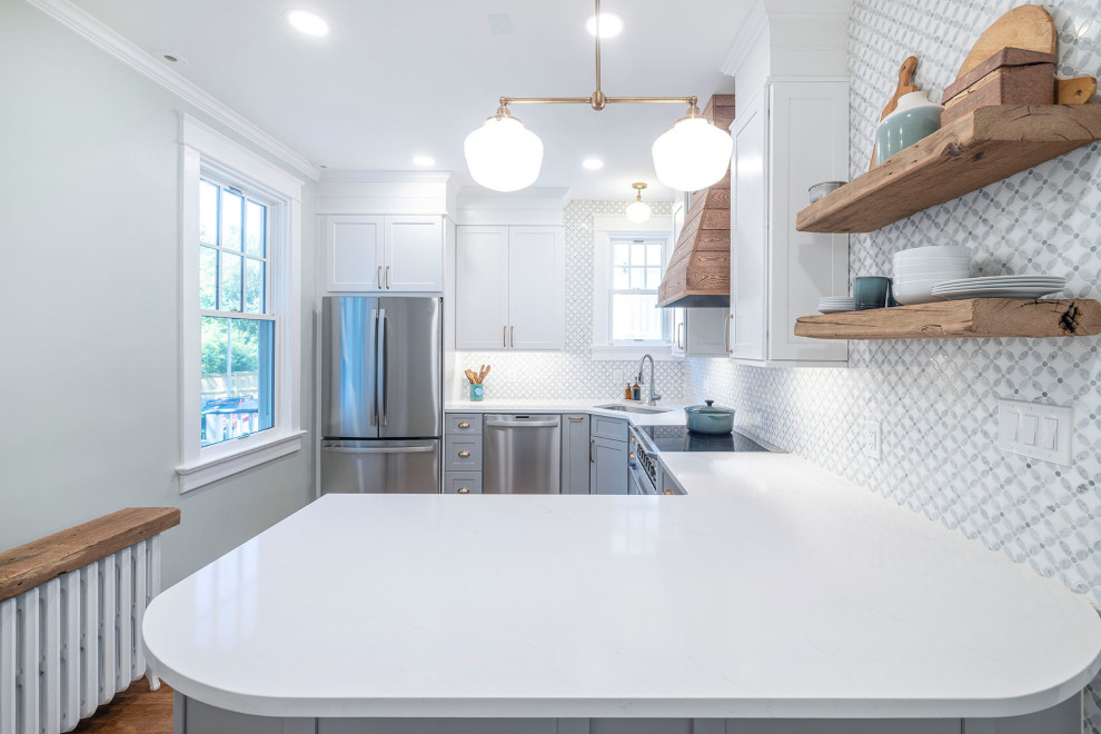 Inspiration for a large farmhouse galley kitchen/diner in DC Metro with a submerged sink, shaker cabinets, grey cabinets, engineered stone countertops, green splashback, marble splashback, white appliances, medium hardwood flooring, a breakfast bar, brown floors and white worktops.