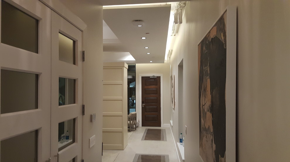 This is an example of a mid-sized contemporary hallway in Houston with grey walls and medium hardwood floors.