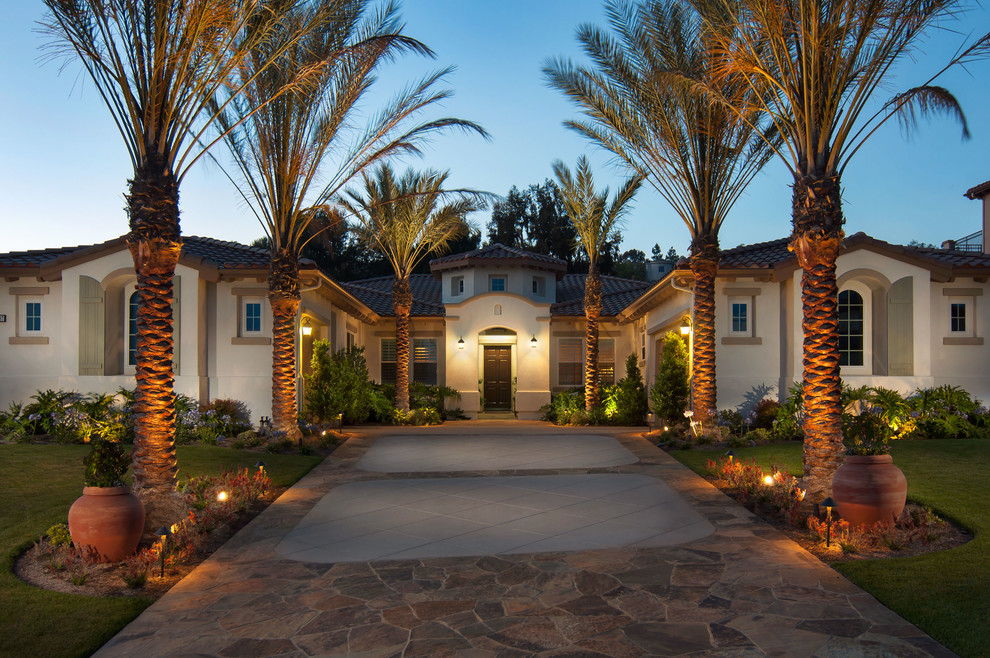 Inspiration for a large mediterranean beige house exterior in Orange County.