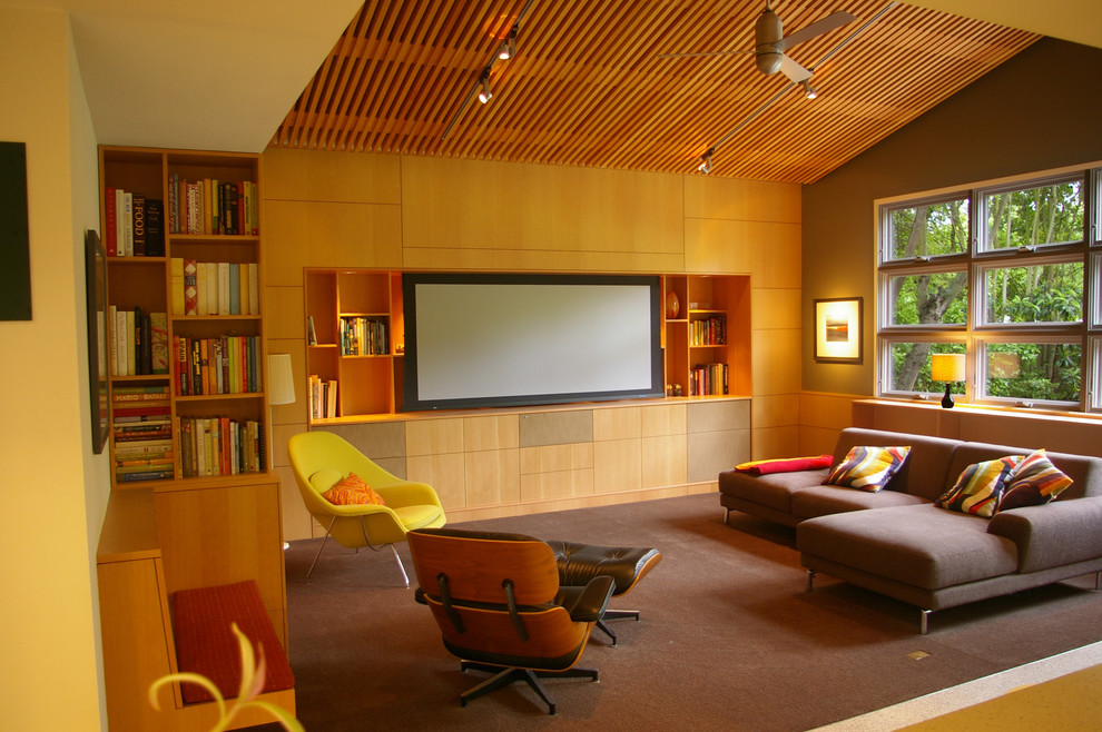 Midcentury family room in San Francisco with green walls, carpet and a built-in media wall.