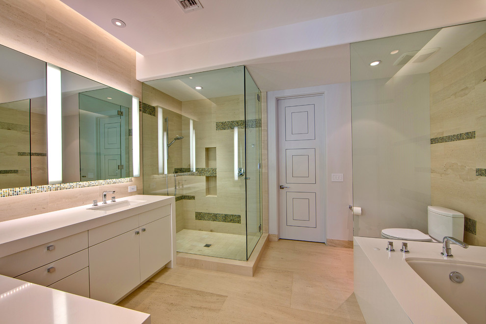 Large contemporary master bathroom in Phoenix with flat-panel cabinets, white cabinets, an undermount tub, a corner shower, a two-piece toilet, beige tile, porcelain tile, white walls, porcelain floors, an undermount sink, engineered quartz benchtops, beige floor, a hinged shower door and white benchtops.
