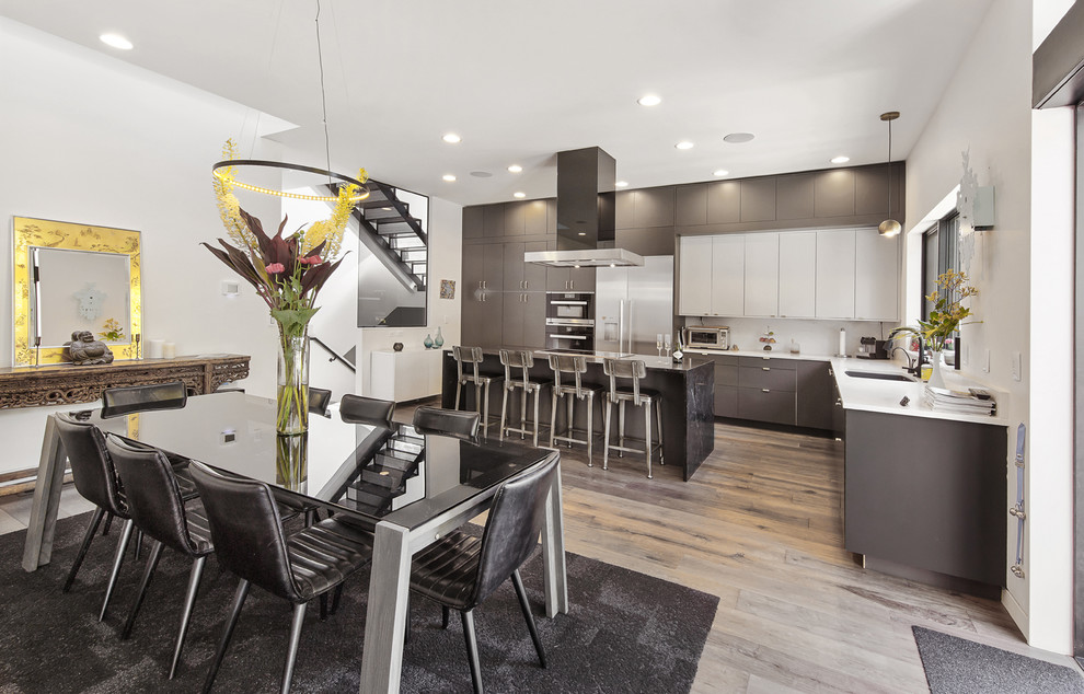 Mid-sized modern l-shaped kitchen in Portland with flat-panel cabinets, grey cabinets and with island.