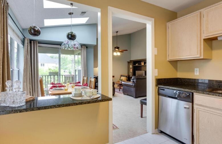 Inspiration for a mid-sized transitional l-shaped vinyl floor enclosed kitchen remodel in Baltimore with a drop-in sink, light wood cabinets, granite countertops, stainless steel appliances and no island