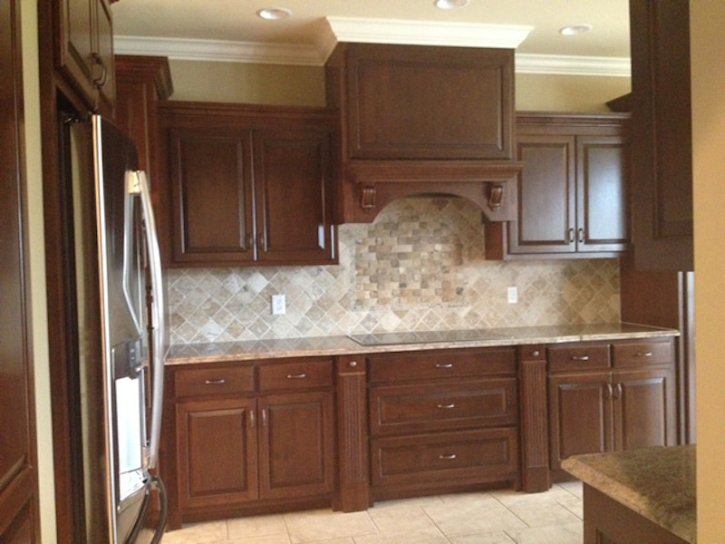 Example of a large ceramic tile kitchen pantry design with recessed-panel cabinets, medium tone wood cabinets, granite countertops and stainless steel appliances