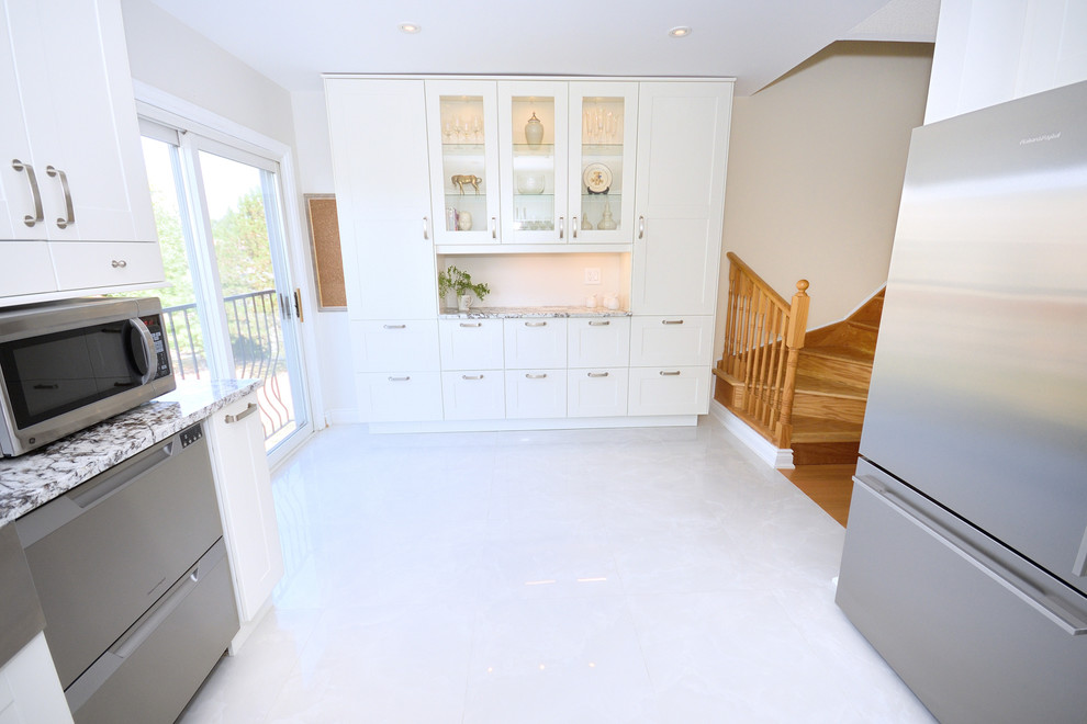 Enclosed kitchen - large transitional u-shaped porcelain tile enclosed kitchen idea in Toronto with a farmhouse sink, white cabinets, beige backsplash, stainless steel appliances, no island, recessed-panel cabinets, quartzite countertops and ceramic backsplash