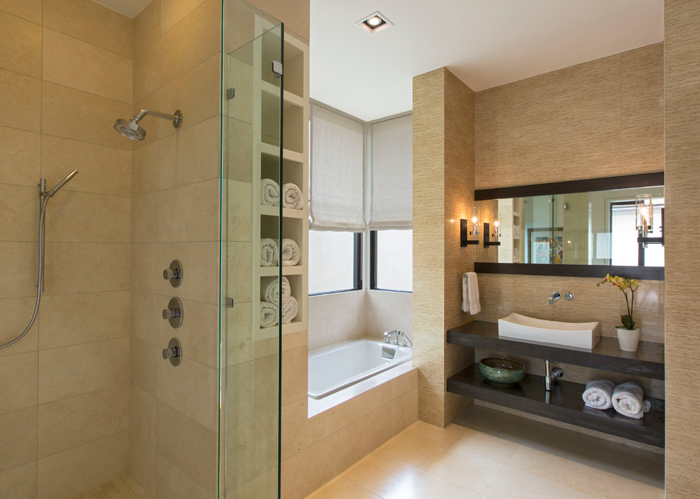 Photo of a mid-sized contemporary master bathroom in Austin with a vessel sink, open cabinets, engineered quartz benchtops, a curbless shower, beige tile, porcelain tile, beige walls, limestone floors, a drop-in tub and dark wood cabinets.