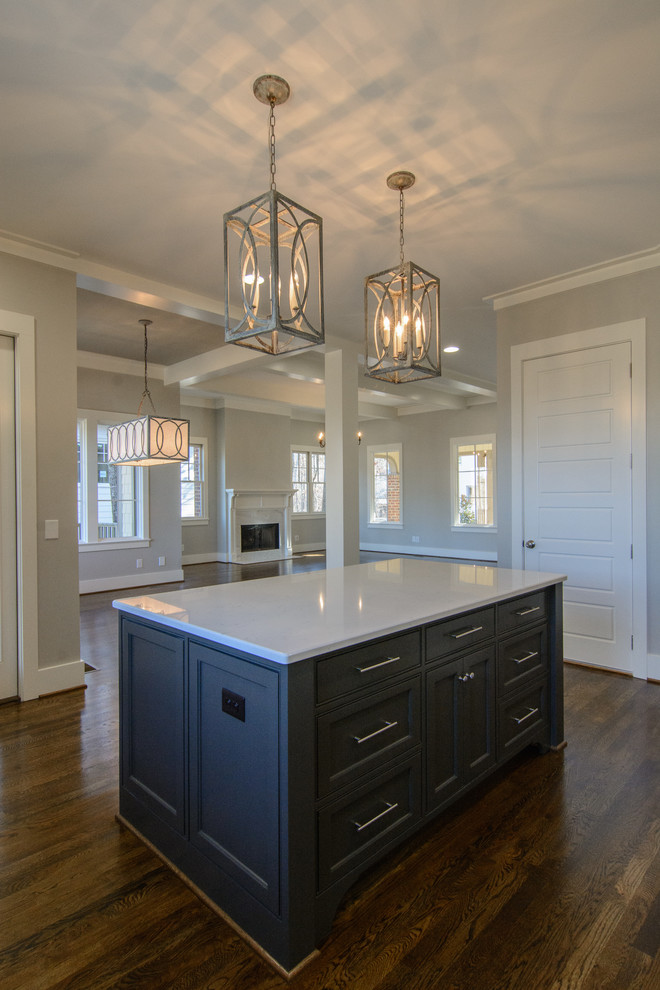 Inspiration for a mid-sized transitional l-shaped dark wood floor open concept kitchen remodel in Birmingham with a farmhouse sink, white cabinets, gray backsplash, stainless steel appliances and an island