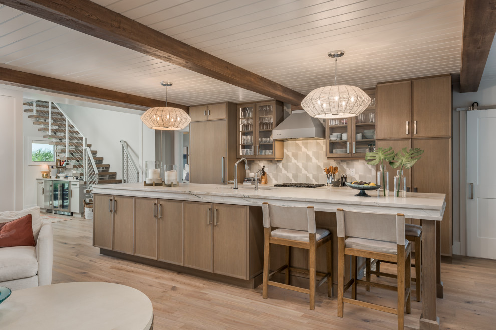 This is an example of a galley kitchen in Tampa with an undermount sink, recessed-panel cabinets, medium wood cabinets, beige splashback, panelled appliances, medium hardwood floors, with island, brown floor, beige benchtop, exposed beam and timber.
