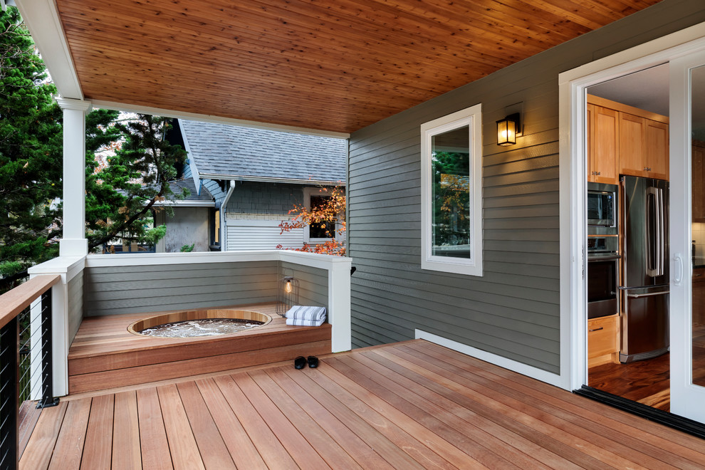 Photo of a transitional deck in Portland with a roof extension.