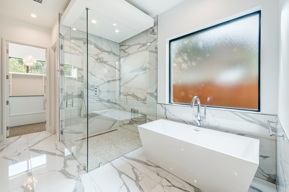 This is an example of a large contemporary master bathroom in Dallas with flat-panel cabinets, light wood cabinets, a freestanding tub, a curbless shower, a two-piece toilet, white tile, porcelain tile, white walls, porcelain floors, an undermount sink, engineered quartz benchtops, white floor, a hinged shower door, white benchtops, an enclosed toilet and a floating vanity.