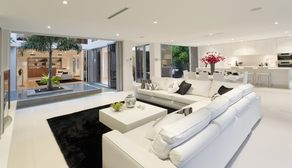 Large contemporary formal open concept living room in Los Angeles with white walls, porcelain floors and white floor.