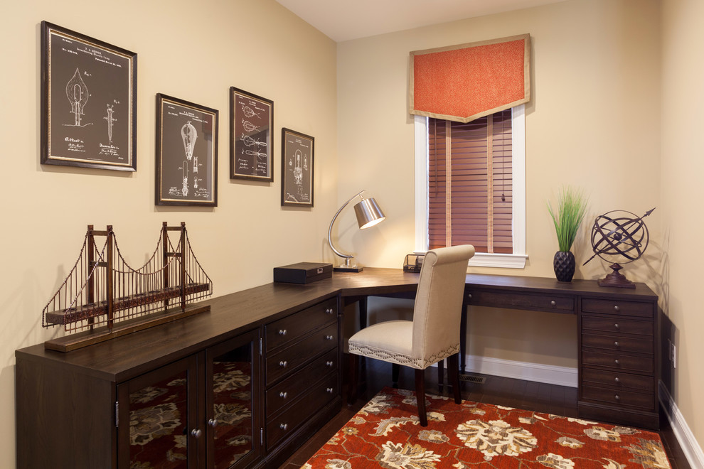 Photo of a small traditional home office in Philadelphia with beige walls, dark hardwood floors and a freestanding desk.