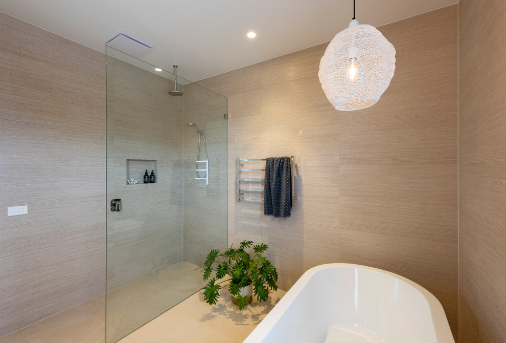 Photo of a contemporary bathroom in Melbourne with flat-panel cabinets, a freestanding tub, brown tile, porcelain tile, brown walls, porcelain floors, a console sink, an open shower, white benchtops, light wood cabinets, an open shower and engineered quartz benchtops.