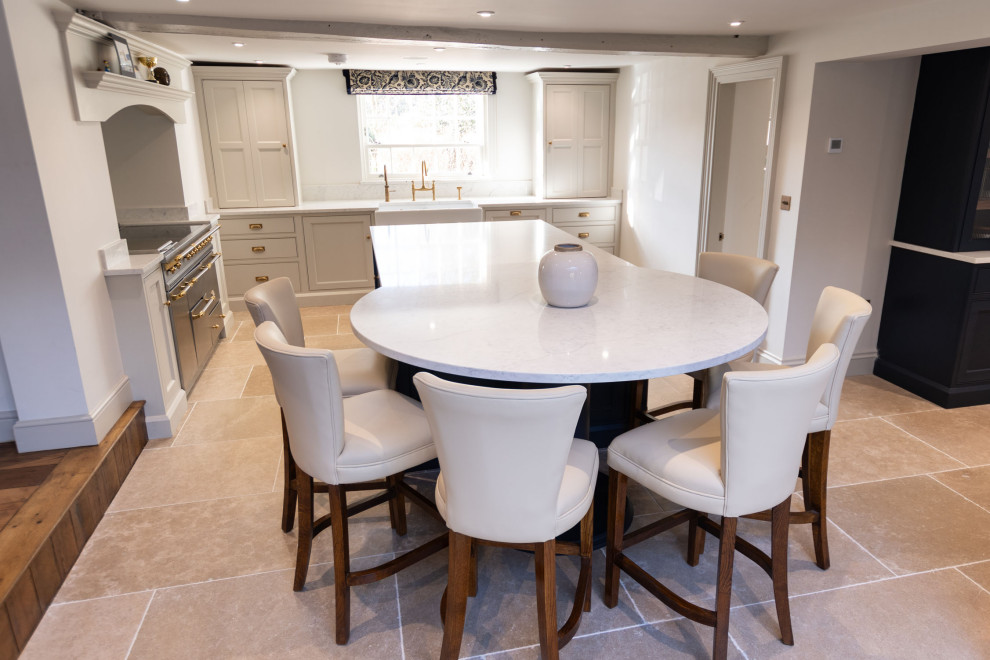 Inspiration for a large country l-shaped open plan kitchen in Essex with a farmhouse sink, shaker cabinets, black cabinets, quartzite benchtops, metallic splashback, glass sheet splashback, stainless steel appliances, limestone floors, with island, beige floor and white benchtop.