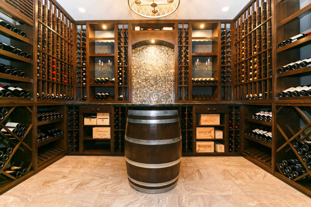 This is an example of a large traditional wine cellar in New York with marble floors and display racks.