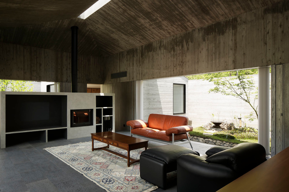 Modern living room in Tokyo with grey walls and a standard fireplace.