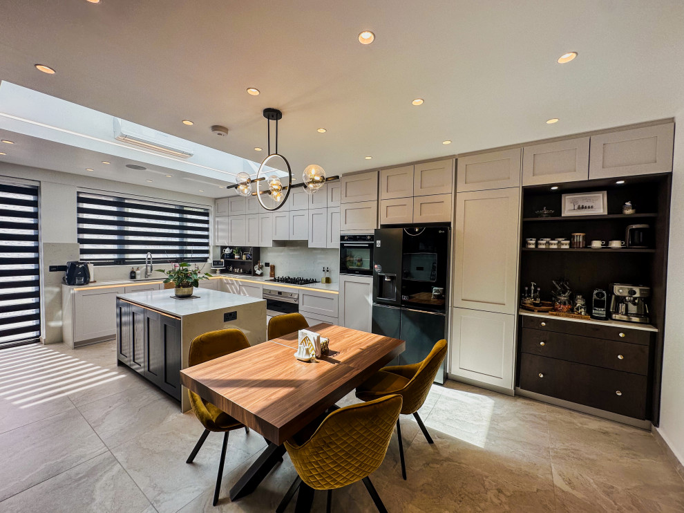 Large traditional kitchen in London with a built-in sink, white splashback, engineered quartz splashback, integrated appliances, porcelain flooring, beige floors and feature lighting.