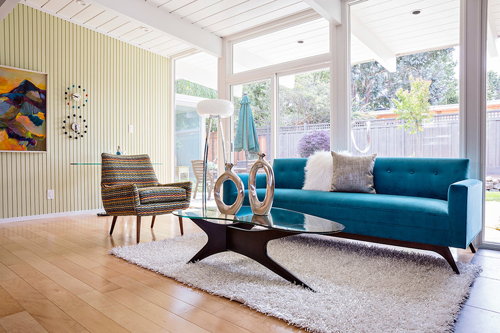Inspiration for a mid-sized 1950s light wood floor living room remodel in San Francisco with green walls, no fireplace and no tv