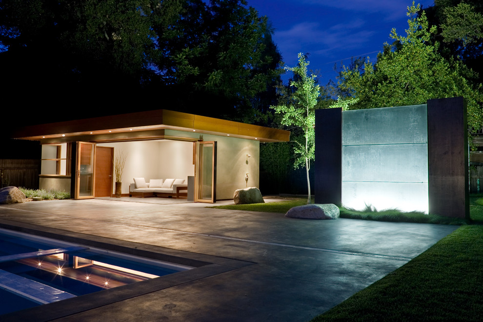Design ideas for a contemporary pool in San Francisco with concrete slab and a pool house.