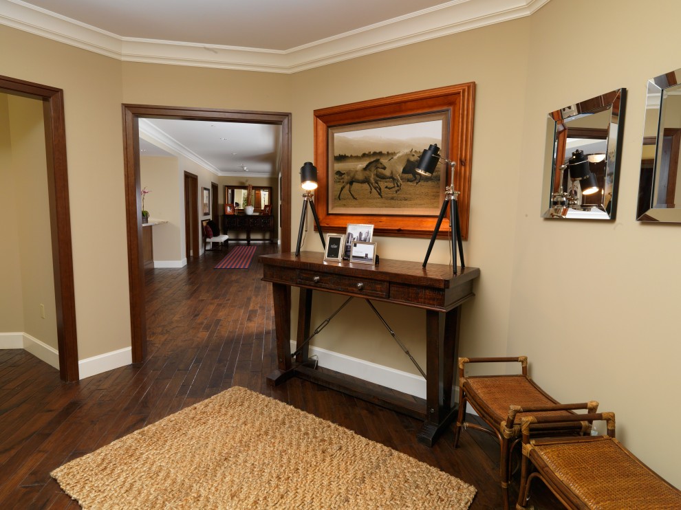 Inspiration for a traditional hallway in Salt Lake City with beige walls, dark hardwood floors and brown floor.