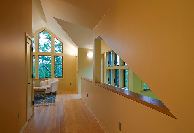 Hallway - small contemporary light wood floor hallway idea in Boston with orange walls