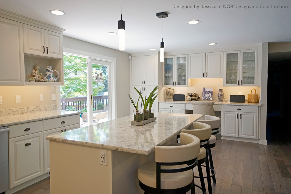 Large transitional u-shaped medium tone wood floor eat-in kitchen photo in Seattle with recessed-panel cabinets, white cabinets, quartzite countertops, stainless steel appliances, an island and white countertops