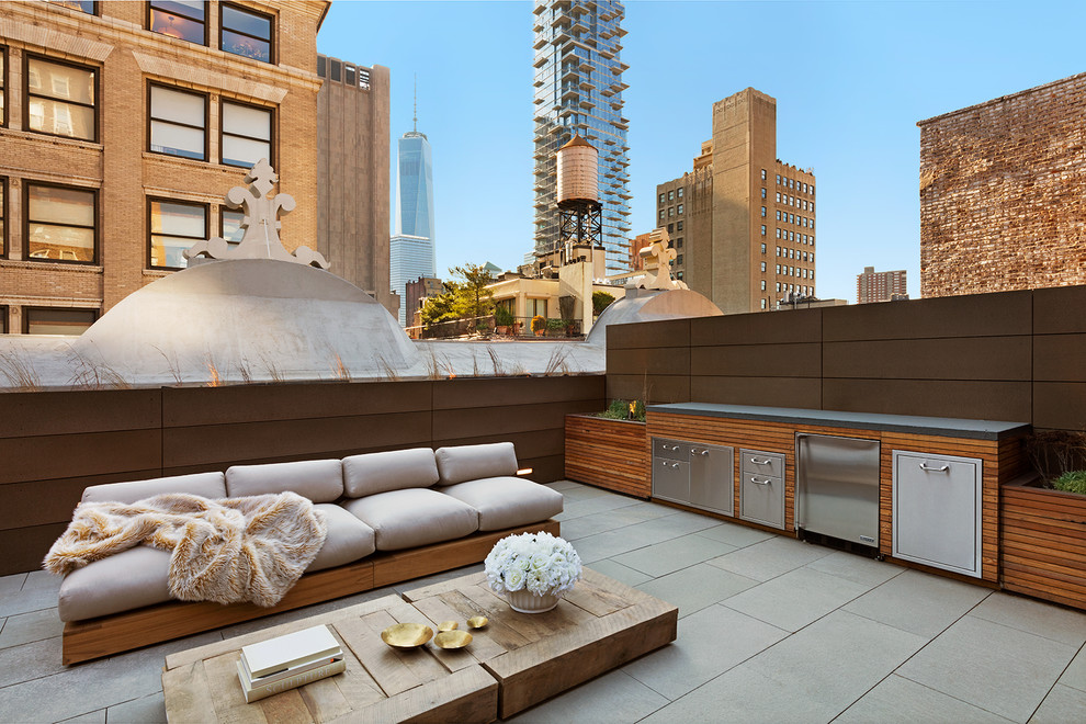 Photo of a large contemporary backyard patio in New York with an outdoor kitchen, concrete pavers and no cover.