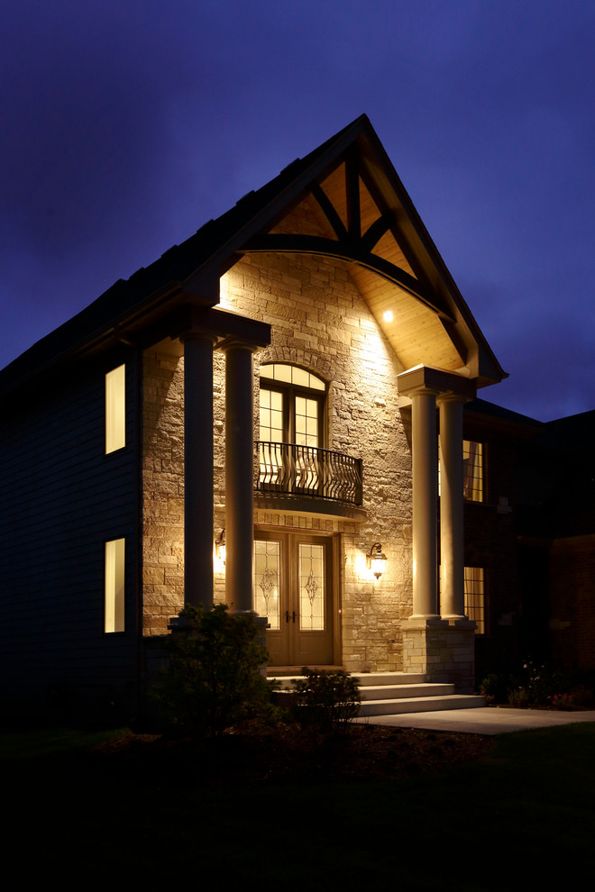 Mid-sized transitional two-storey beige exterior in Chicago with stone veneer and a gable roof.
