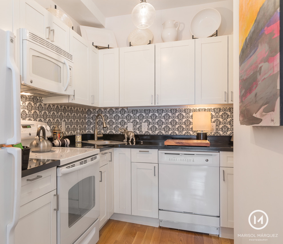 Kitchen - eclectic galley kitchen idea in Boston with raised-panel cabinets and no island