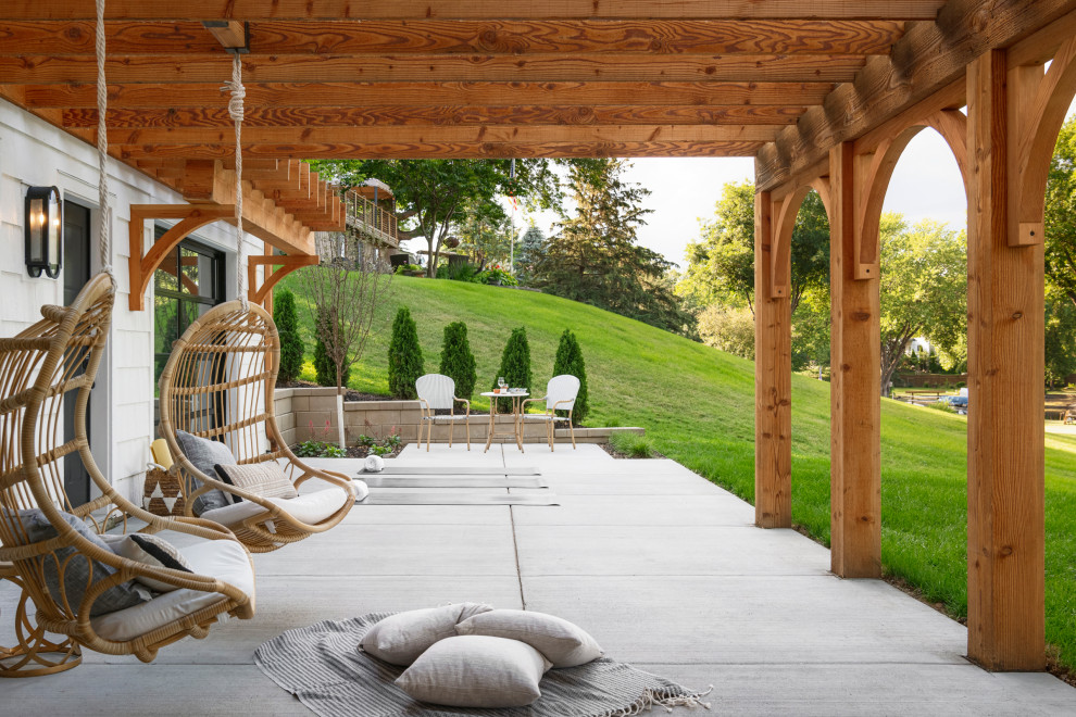 Inspiration for a mid-sized mediterranean backyard patio in Minneapolis with a fire feature, natural stone pavers and a pergola.