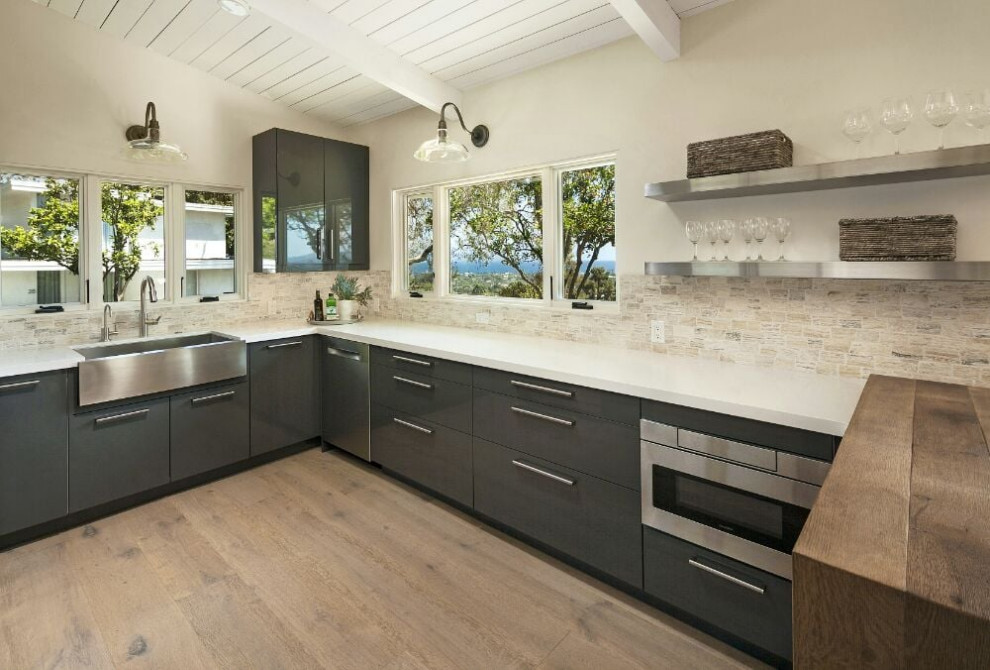 This is an example of a medium sized farmhouse l-shaped open plan kitchen in New York with an integrated sink, raised-panel cabinets, brown cabinets, quartz worktops, white splashback, mosaic tiled splashback, coloured appliances, laminate floors, no island, grey floors, white worktops and a drop ceiling.