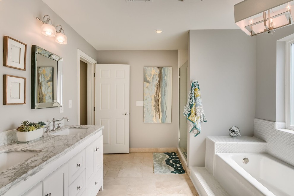 Large transitional porcelain tile and beige floor alcove bathtub photo in Phoenix with recessed-panel cabinets, white cabinets, beige walls, an undermount sink and marble countertops
