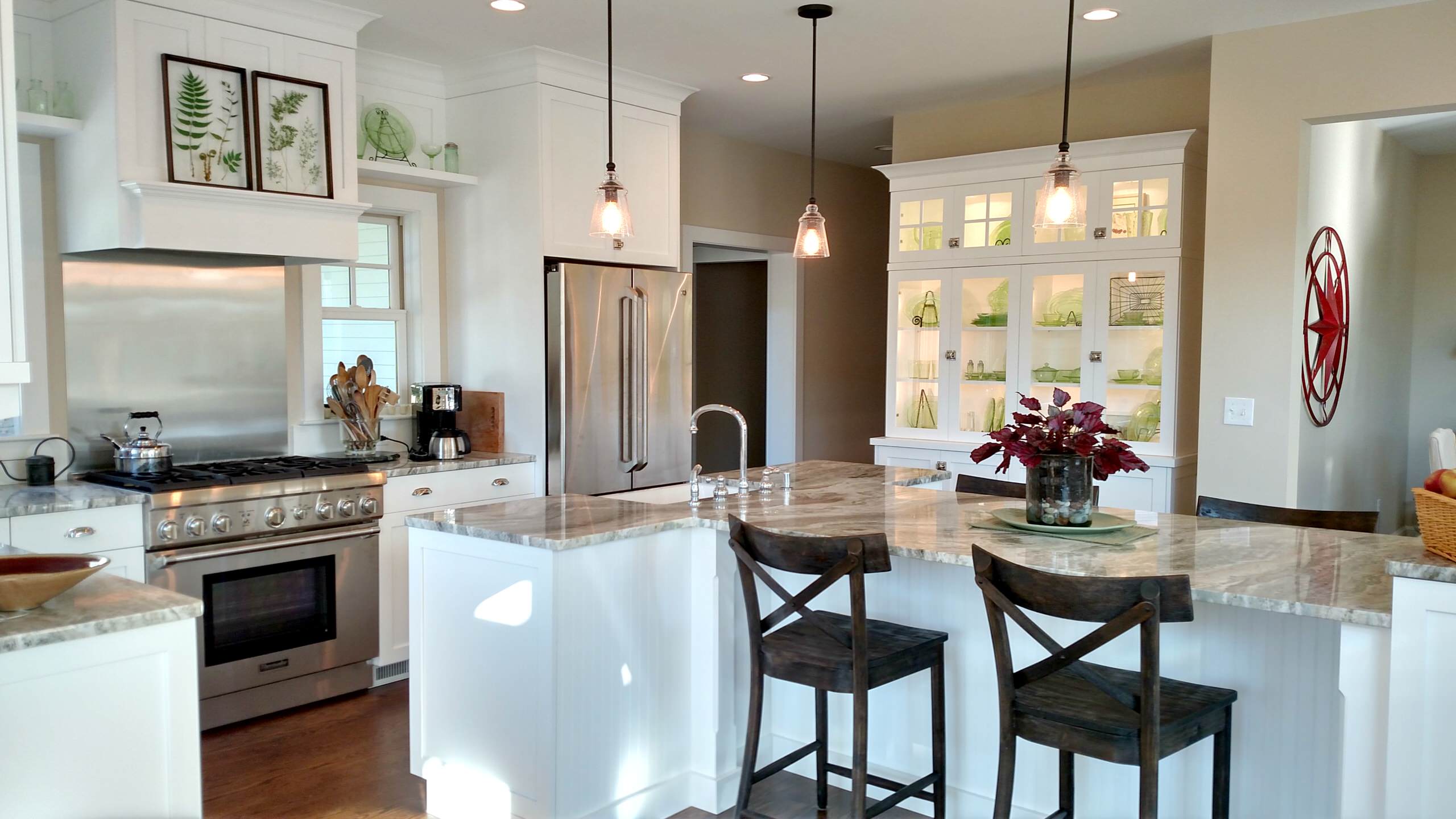 Crispy white cabinets display the homeowner's beautiful green glass collection!