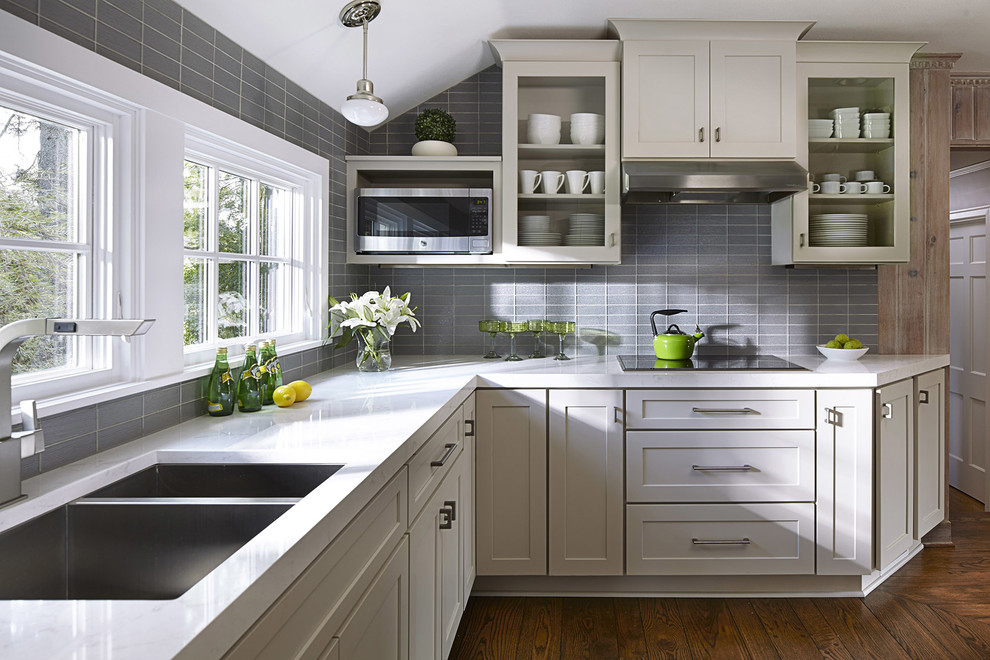 Design ideas for a mid-sized transitional l-shaped kitchen in Atlanta with grey cabinets, grey splashback, glass tile splashback, stainless steel appliances, no island, a double-bowl sink, dark hardwood floors and shaker cabinets.