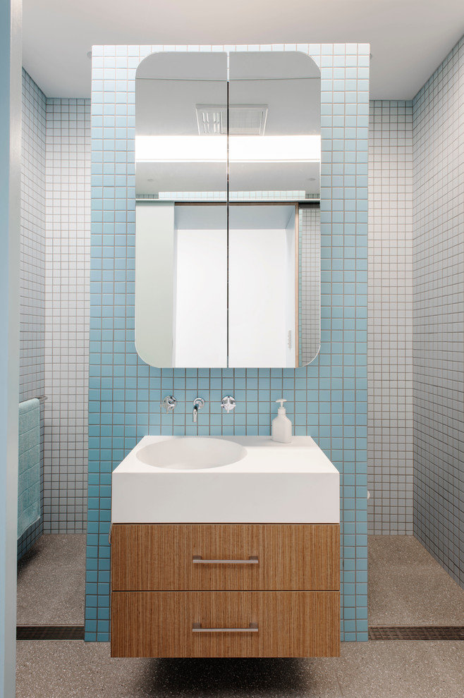 Design ideas for a small contemporary master bathroom in Sydney with flat-panel cabinets, medium wood cabinets, solid surface benchtops, an alcove shower, a one-piece toilet, blue tile, ceramic tile and blue walls.