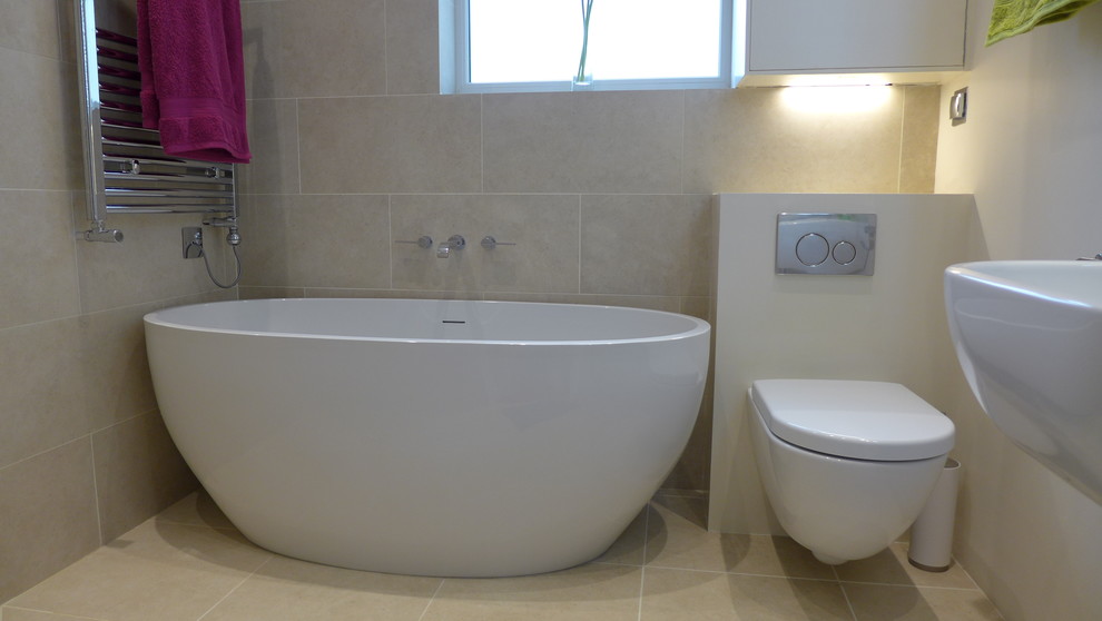 Photo of a small contemporary 3/4 bathroom in Other with a wall-mount sink, a freestanding tub, an open shower, beige tile, porcelain tile and porcelain floors.
