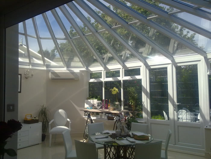 This is an example of a mid-sized contemporary sunroom in London.