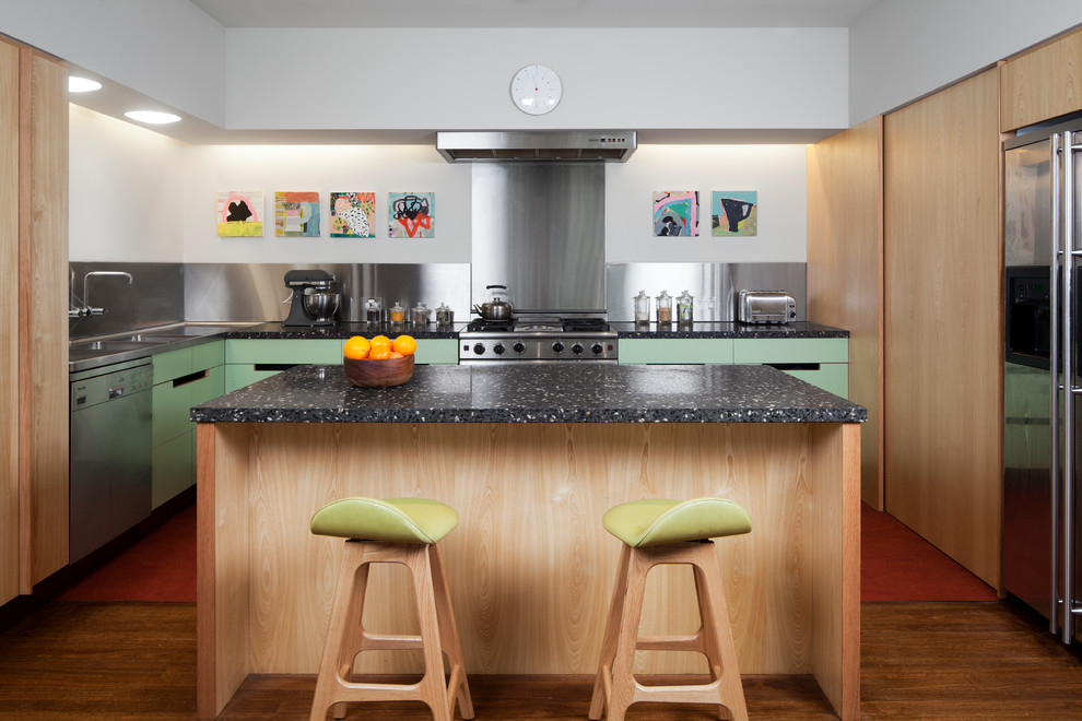 Design ideas for a contemporary l-shaped open plan kitchen in Sydney with a double-bowl sink, flat-panel cabinets, turquoise cabinets, solid surface benchtops, black splashback, stainless steel appliances, dark hardwood floors, with island and brown floor.