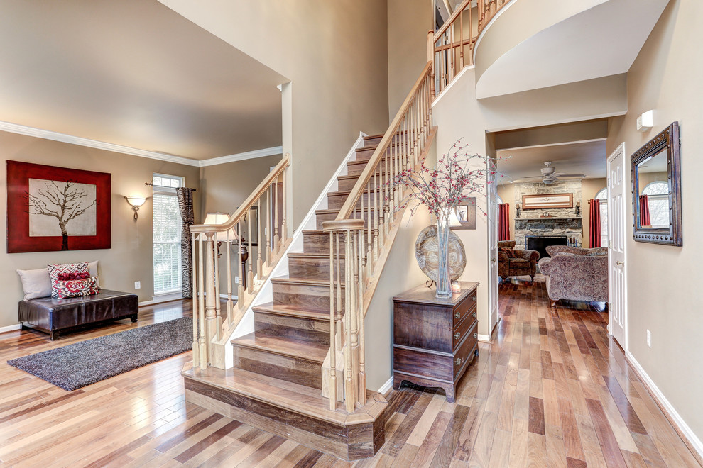 Photo of a large transitional foyer in DC Metro with grey walls and medium hardwood floors.