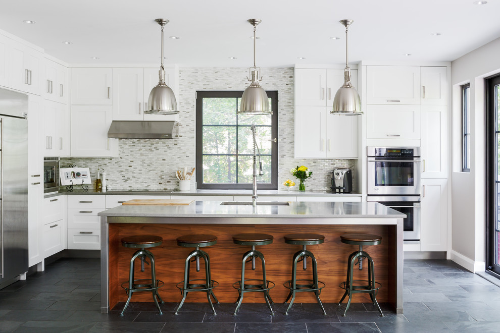 Inspiration for a transitional galley eat-in kitchen in San Francisco with shaker cabinets, white cabinets, grey splashback, mosaic tile splashback, stainless steel appliances, with island, a double-bowl sink and ceramic floors.