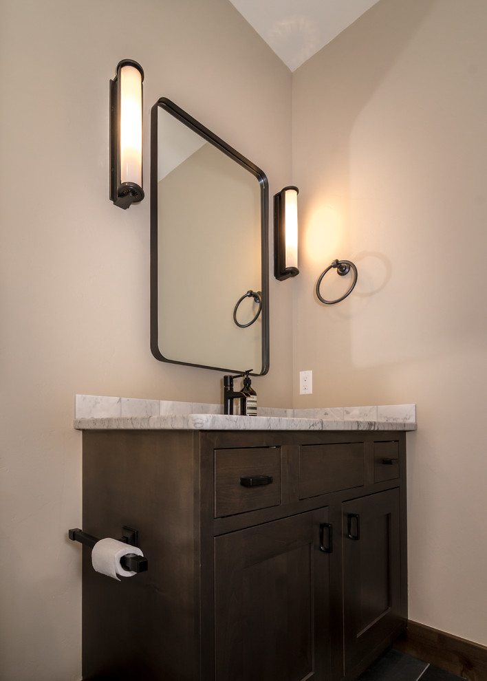 Mid-sized mountain style 3/4 slate floor and gray floor bathroom photo in Denver with shaker cabinets, dark wood cabinets, beige walls, an undermount sink, marble countertops and gray countertops