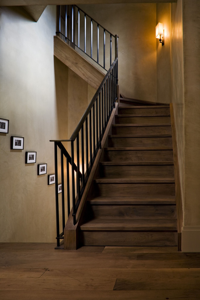 Contemporary wood staircase in New York with wood risers and metal railing.