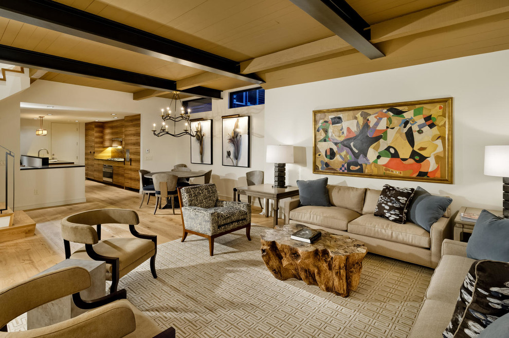 Photo of a contemporary open concept living room in Denver with white walls and light hardwood floors.